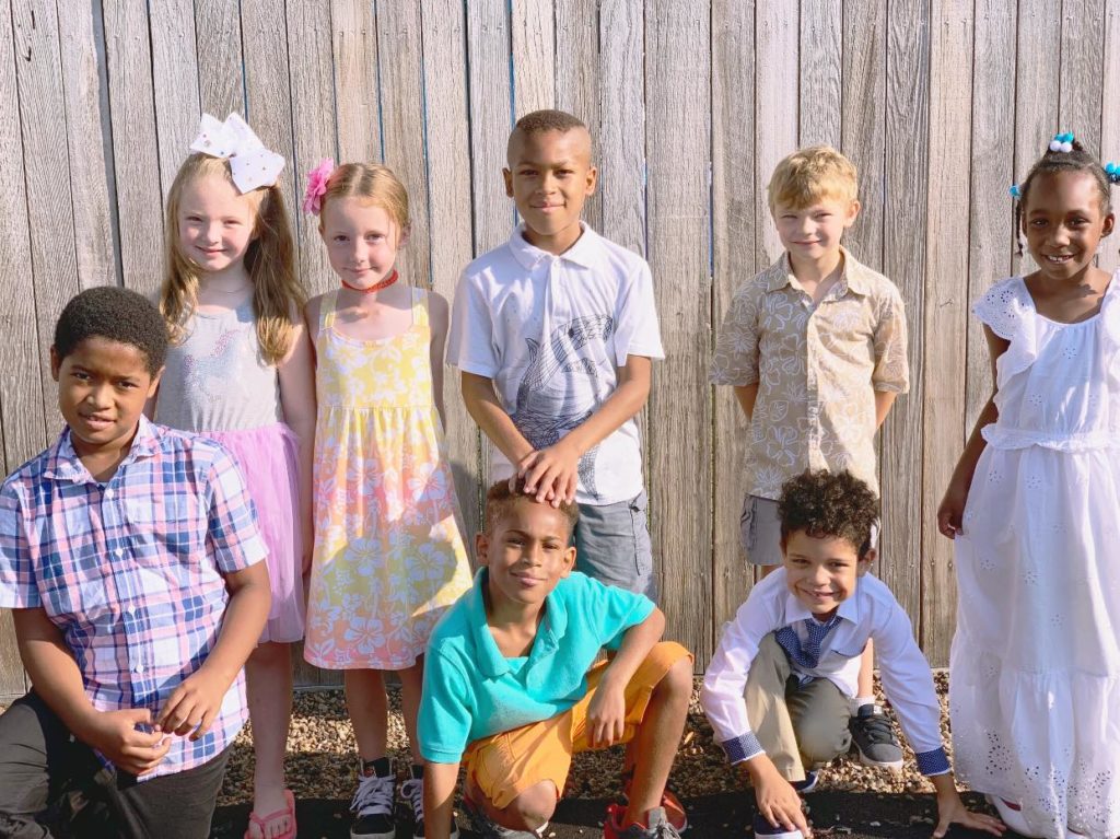 Group of happy kids posing on their school yard at a Preschool & Daycare Serving Hampton Roads, VA