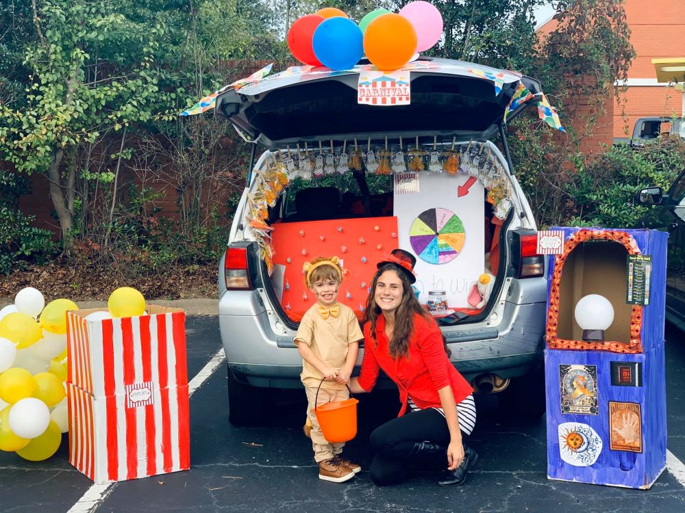 Pretty mom and her daughter wearing magician outfits while on the back of their car that they used as props for a school activity at a Preschool & Daycare Serving Hampton Roads, VA