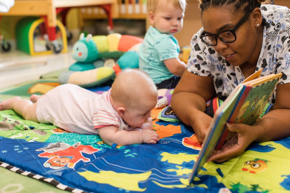 Teacher reading and storytelling to the babies at a Preschool & Daycare Serving Hampton Roads, VA