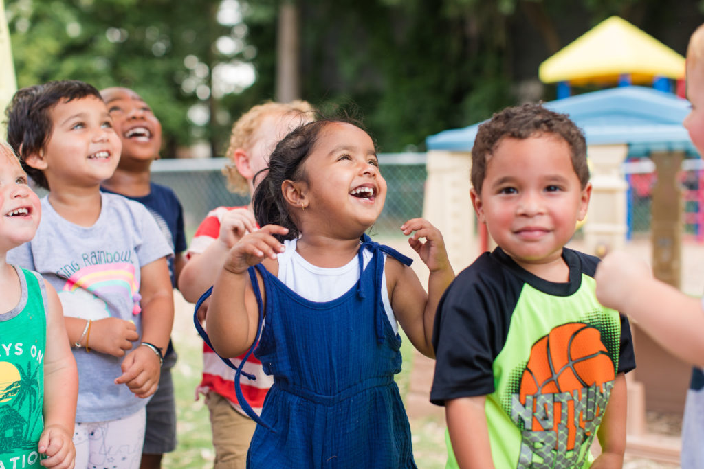 Happy group of diverse little you ones enjoying at the playground at a Preschool & Daycare Serving Hampton Roads, VA