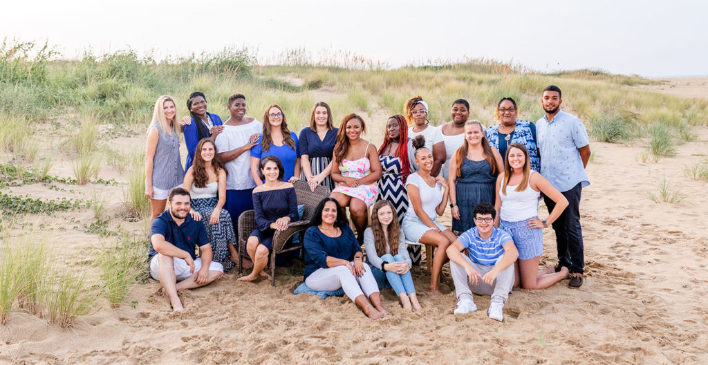 Nursery and Preschool teachers gather together a photo shoot on a beautiful sandy location at a Preschool & Daycare Serving Hampton Roads, VA